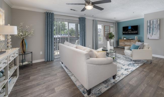 a living room with a white couch and a wood floor