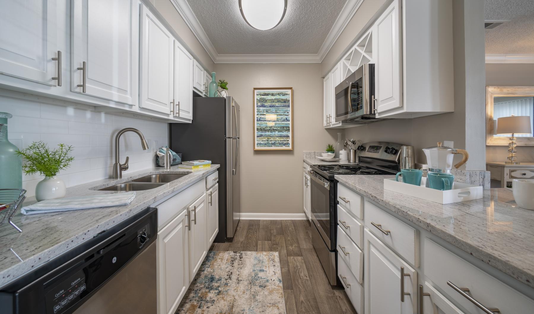 a kitchen with white cabinets