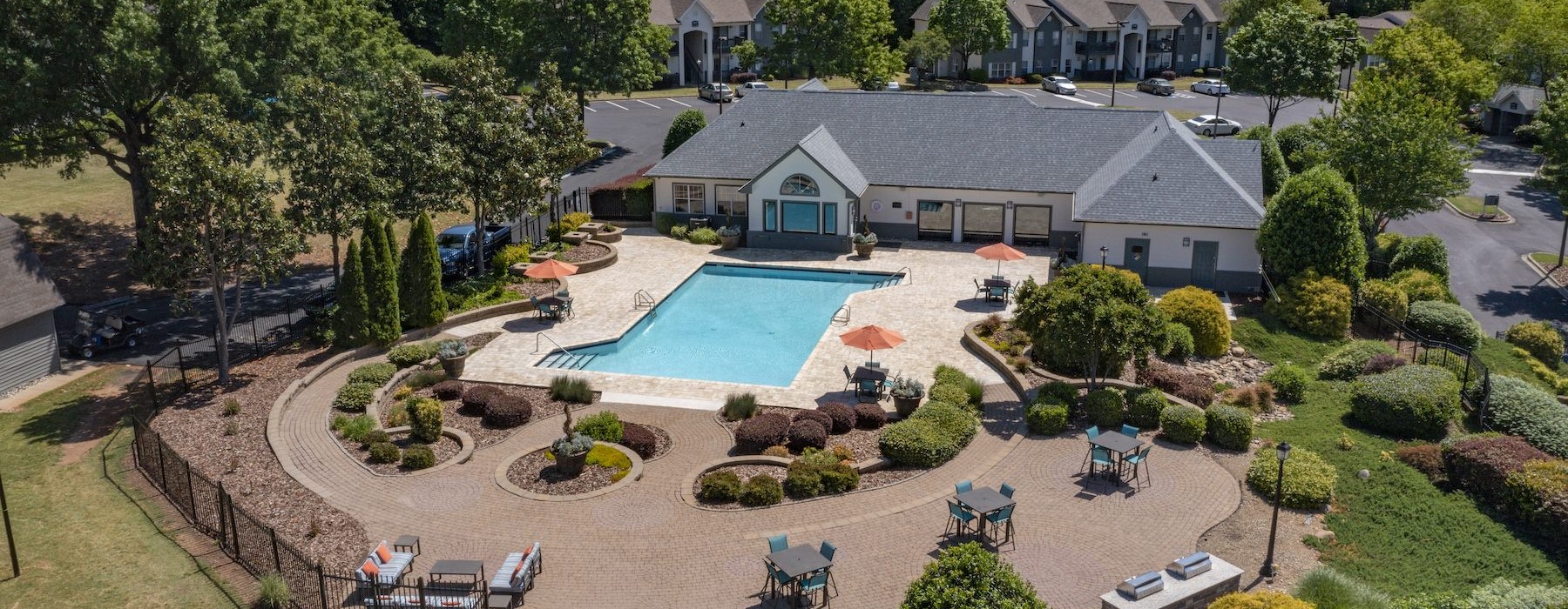 a building with a pool and trees around it