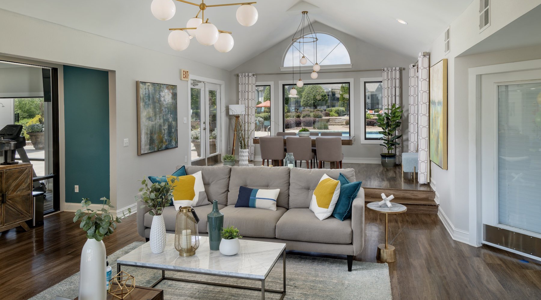 a clubroom with a couch, tables and chairs
