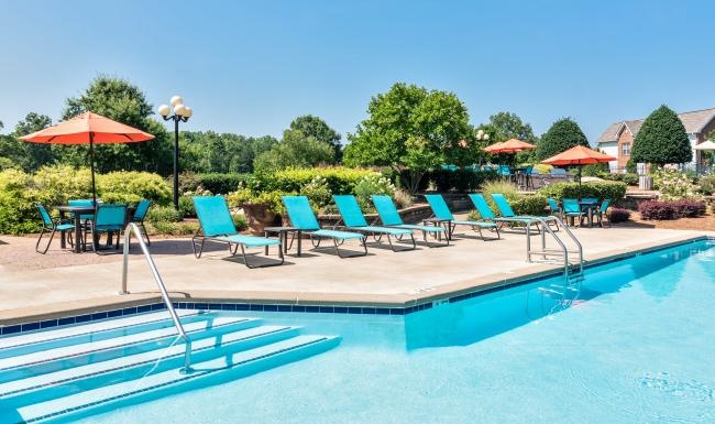 a pool with chairs around it